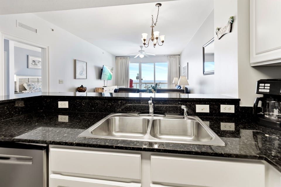 Your kitchen's granite counters and double sink make meal prep effortless while you enjoy stunning ocean views through the living room.