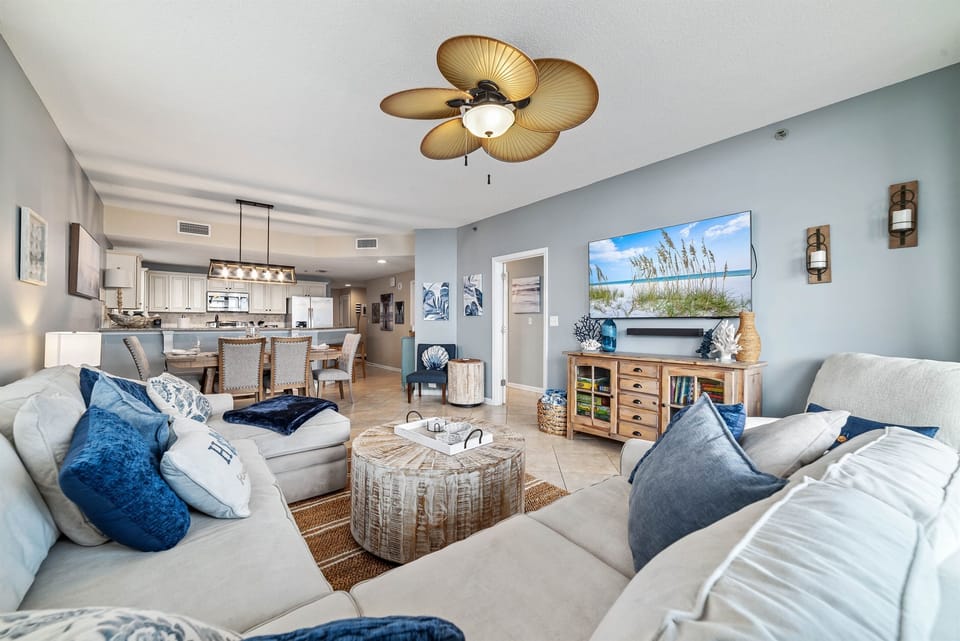This well-appointed living space offers a comfortable sectional sofa, elegant coffee table, and a dining area with seating for six, creating a welcoming atmosphere.