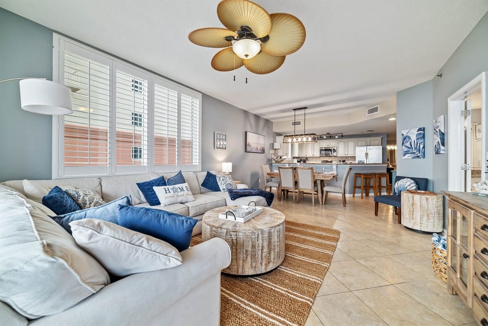 Subtle coastal touches and a neutral palette create a serene and relaxing ambiance in this open living and dining space.