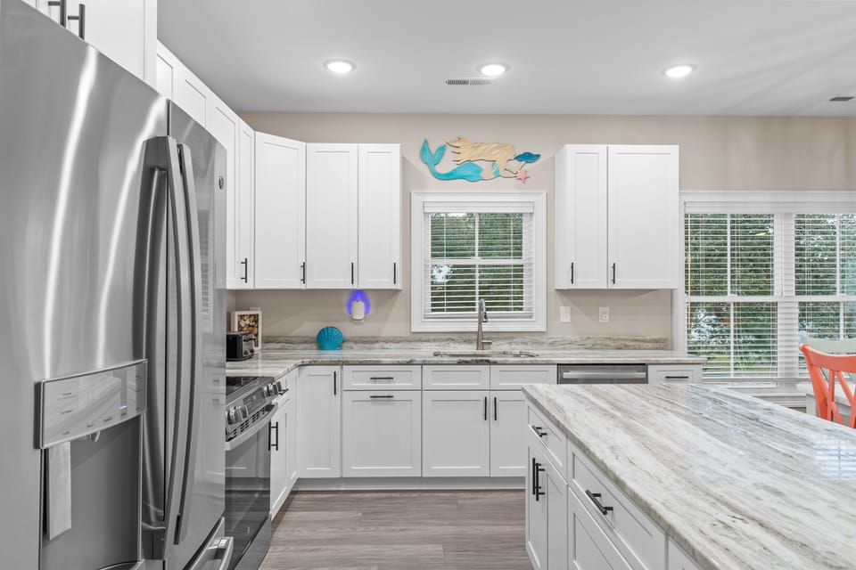 Your spacious kitchen features gleaming granite countertops, stainless steel appliances, and abundant storage for all your culinary adventures.