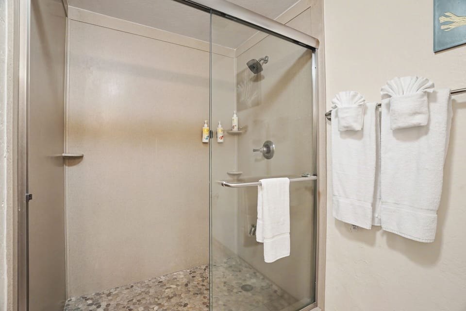 Step into your spa-inspired walk-in shower with a soothing rainfall head, built-in bench, and fluffy towels waiting for you after a refreshing rinse.