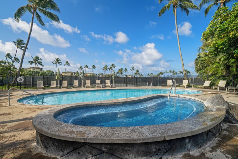Lounge poolside under swaying palms and soak in the hot tub, framed by lush tropical gardens and island breezes.