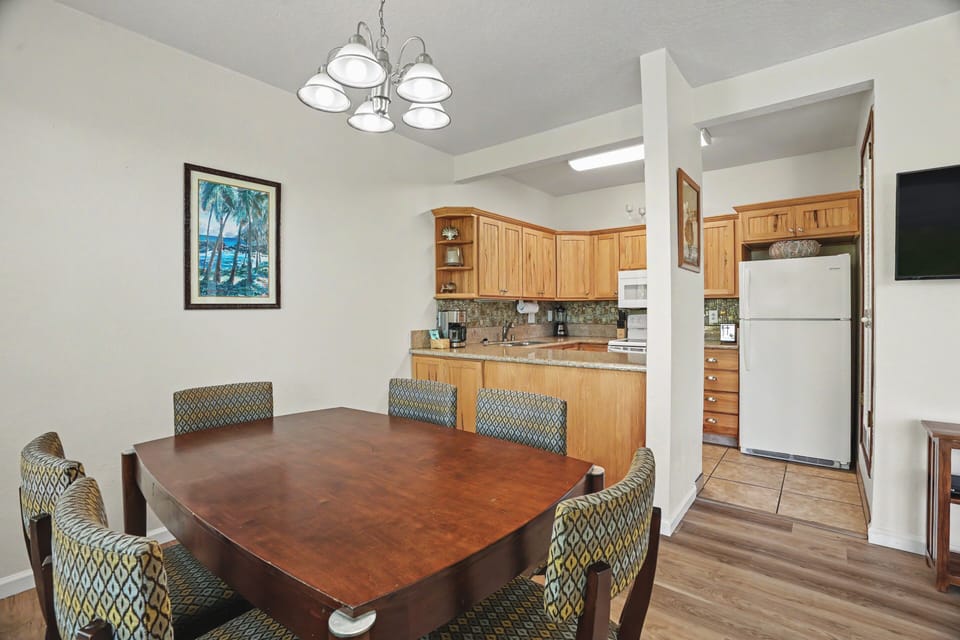 Gather around this handsome dining table for meals and memories, with a fully-equipped kitchen just steps away for your culinary adventures.