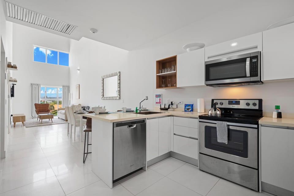 Enjoy the convenience of a fully equipped kitchen with modern appliances & a spacious layout - Prepare meals with ease while staying connected to the bright, open living space - Sleek design & natural light make this a perfect place to gather