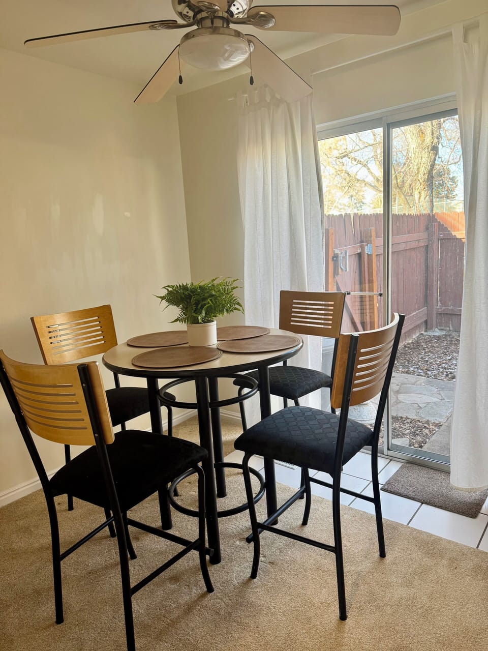 Dining area attached to kitchen seats four.