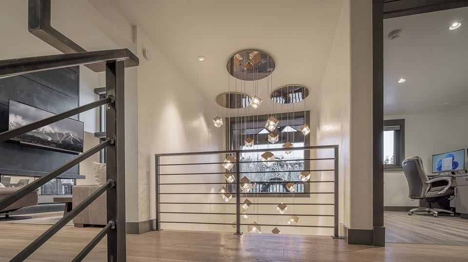 Stairs from entryway to main floor showing office and living room