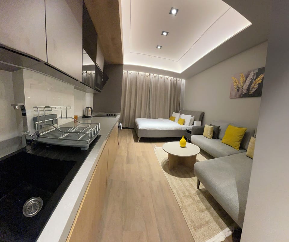 Luxury Studio Suite, Courtyard View | Living area | Flat-screen TV, printers
