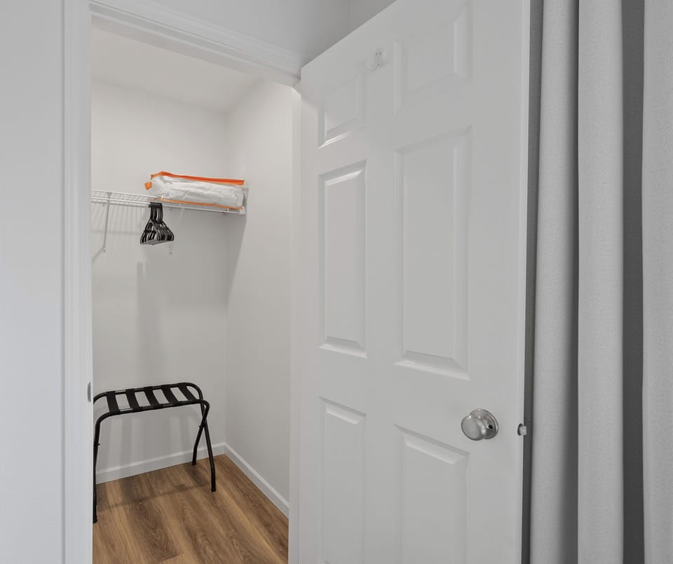 Spacious closet with luggage rack, and hangers