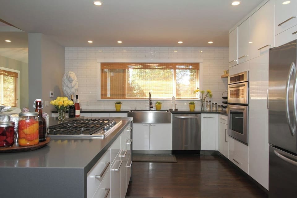 Cook like a pro in this sleek, modern kitchen with stainless appliances, a gas cooktop, and a farmhouse sink. Crisp white cabinetry and quartz counters create a bright, stylish space. Spacious and beautifully designed—perfect for cooking and gathering!
