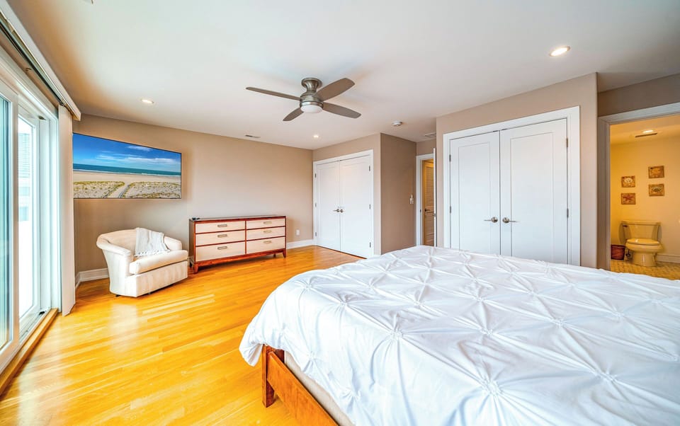 Spacious Master Bedroom with a Queen-sized Bed, Private Balcony & Ensuite Bath