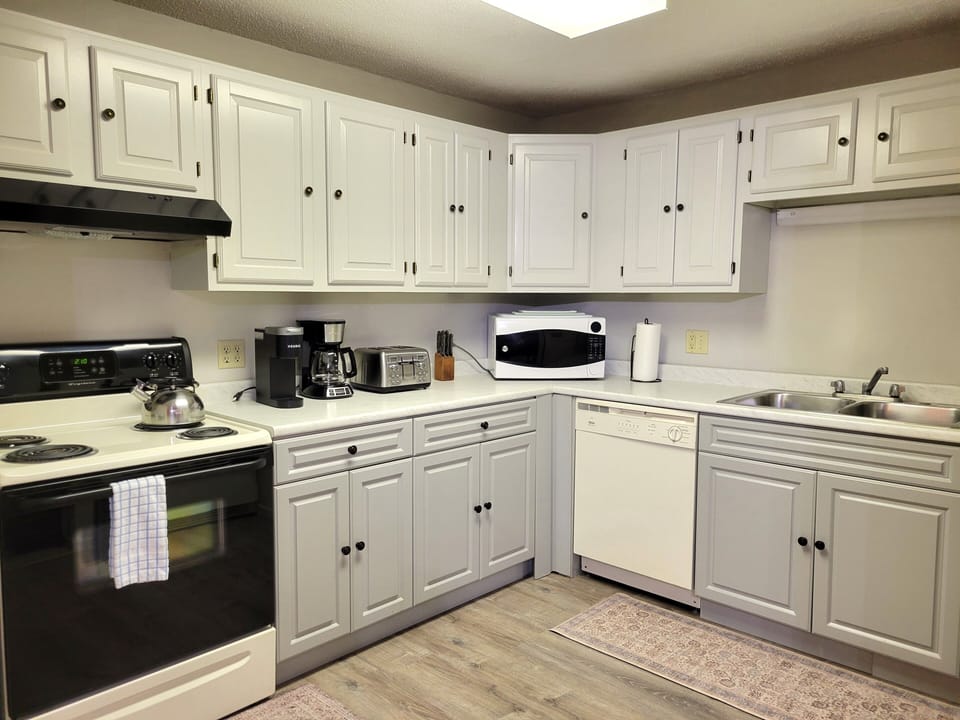 Kitchen is fully stocked with pots & pans, dishes, silverware and cooking utensils.  There is a 12-cup coffee maker & a Keurig, and a crockpot.