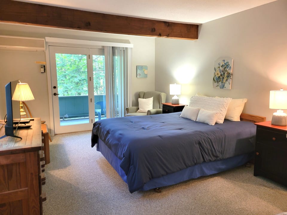 Master bedroom has a flat screen TV.