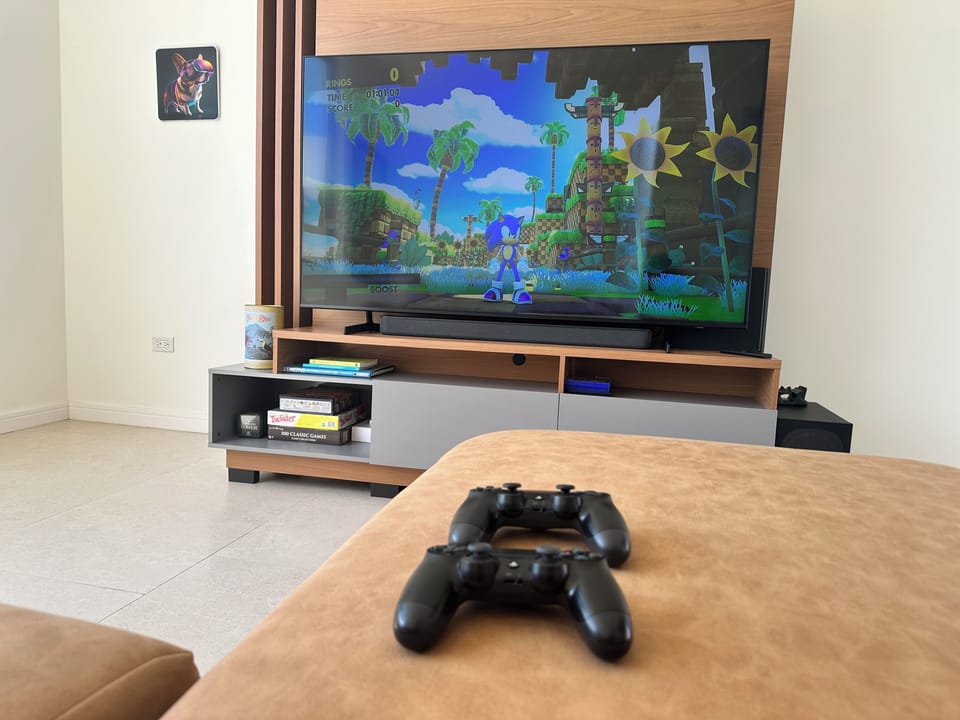 Game room with 65" tv, PS4 w/ 2 controllers, board games, foosball table.
