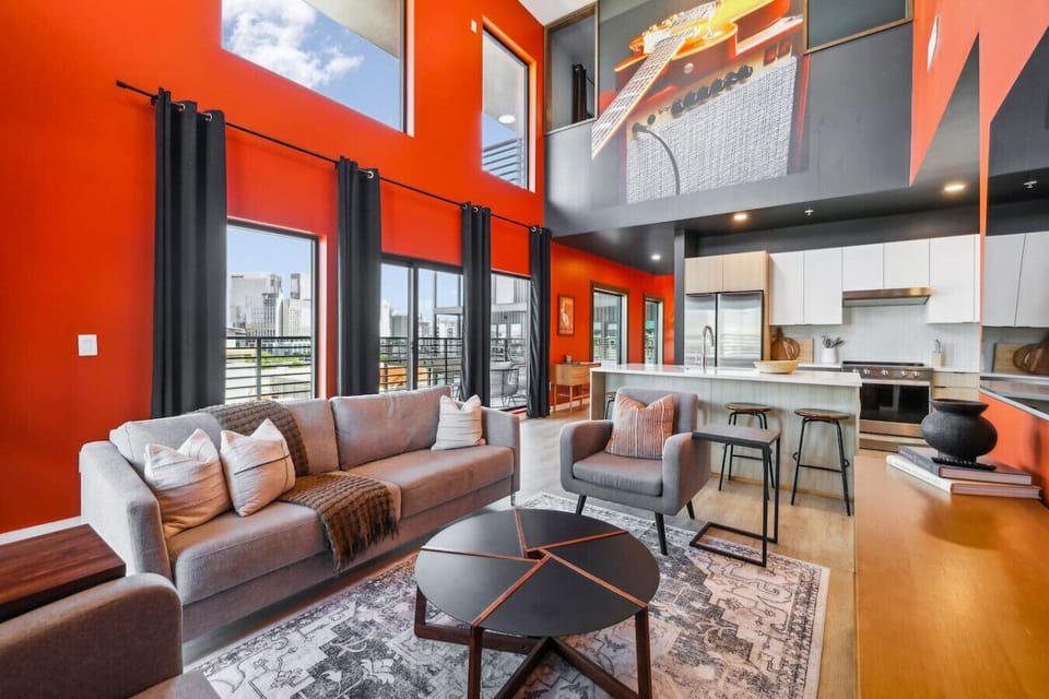 Open concept living/dining/kitchen with vaulted penthouse ceilings