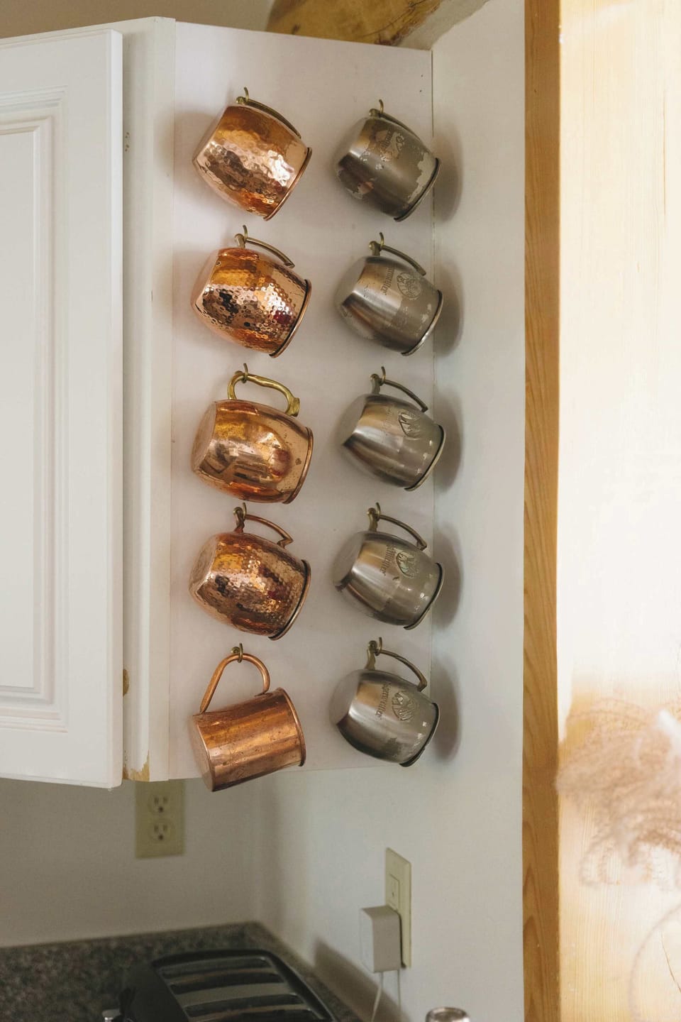 Kitchen: Drip coffee maker, blender, cooking utensils, tableware, coffee mugs. 