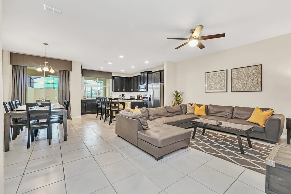 Open-concept living and dining area with modern kitchen and ample seating for family gatherings.