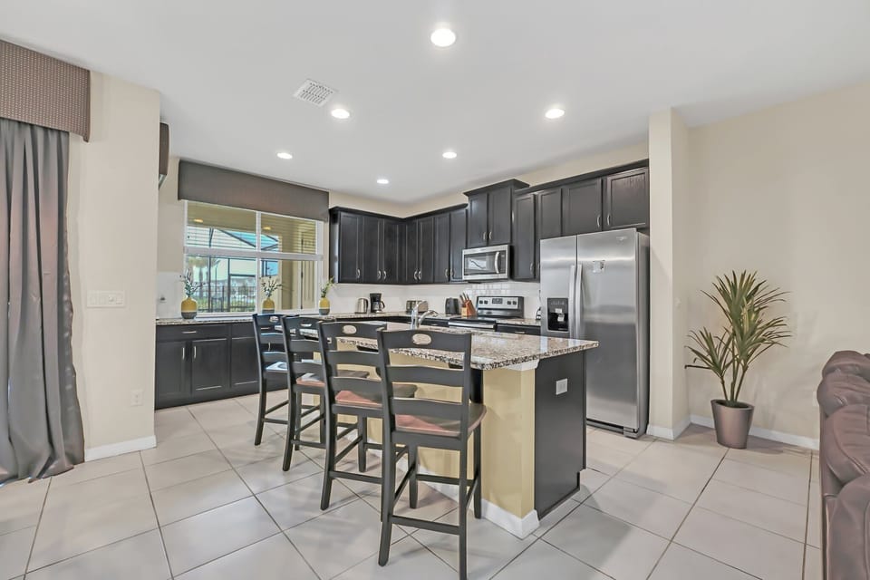 Modern kitchen with granite island and stainless steel appliances