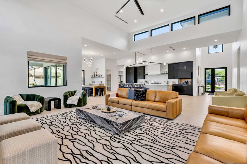 Spacious living space and massive floor rug. Leather couches