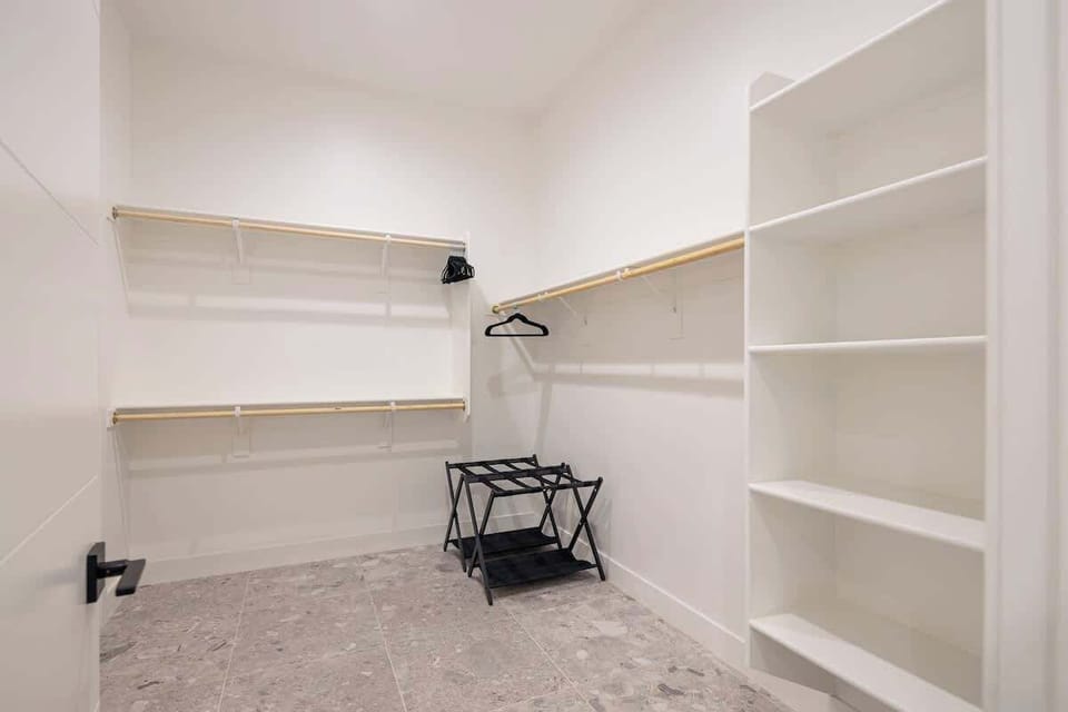 Large walk-in master closet with custom shelving