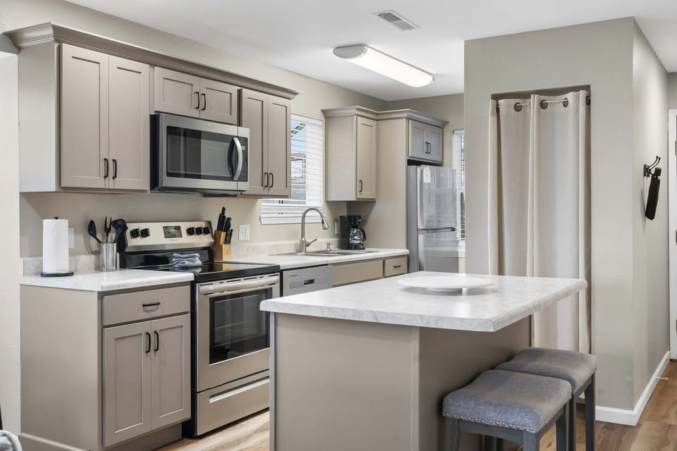 The bright, open kitchen offers ample space & every home comfort