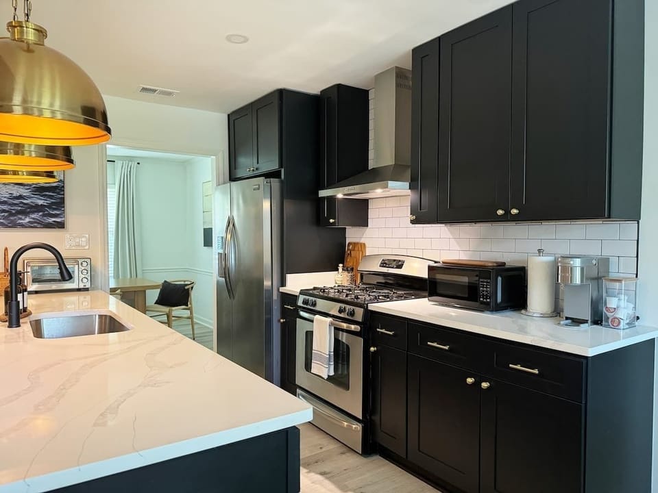 Sophisticated Cooking - Dark, modern kitchen combining design and practicality. 