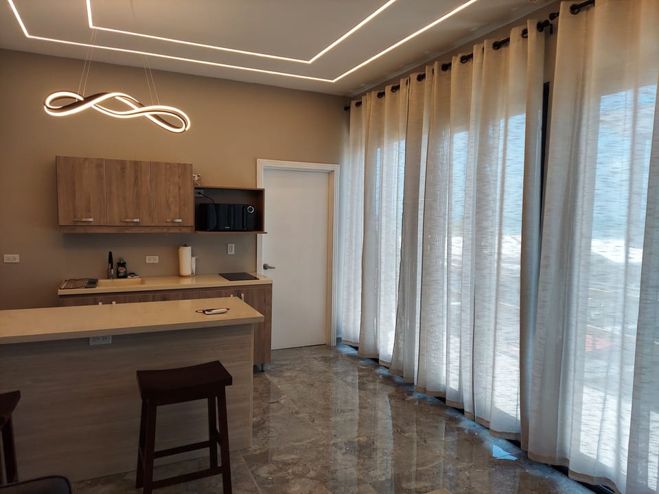 Deluxe Single Room, Kitchenette, Pool View | Living area | 42-inch Smart TV with digital channels, Netflix, streaming services