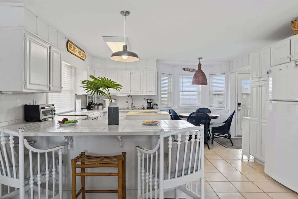 Bringing the beach to your cooking space!  This bright and airy kitchen is the heart of the home, where coastal charm meets modern convenience. Whip up your favorite meals while soaking in those refreshing seaside vibes  #BeachHouseKitchen 