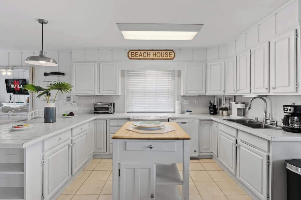 A kitchen where coastal charm meets culinary creativity!  With beachy hues, fresh ocean vibes, and all the essentials for a delicious getaway, this space is ready for your next seaside feast #BeachHouseKitchen 