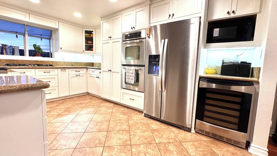 Well stocked kitchen. Dual oven, 5-burner stove, fridge, microwave, wine cooler