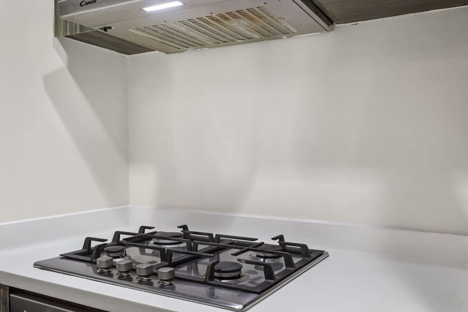 Kitchen: Modern gas stove awaits your culinary adventures in style!