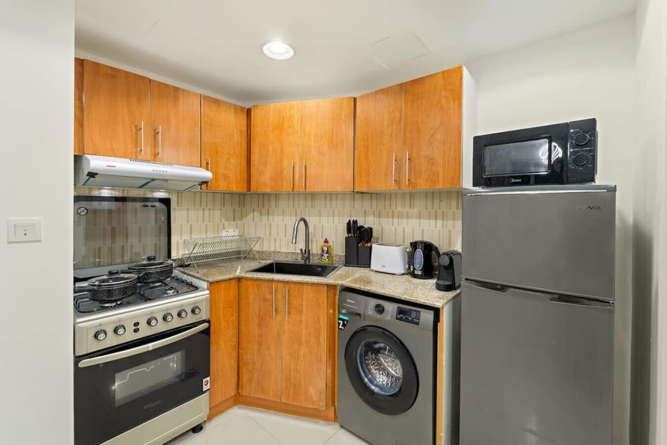 Kitchen: Cook up a storm in this modern kitchen with sleek appliances and stylish wood finishes!