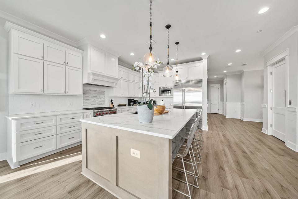 Your spacious chef's kitchen features gleaming white cabinets, marble countertops, and a stunning island where you'll love preparing meals and gathering with friends.