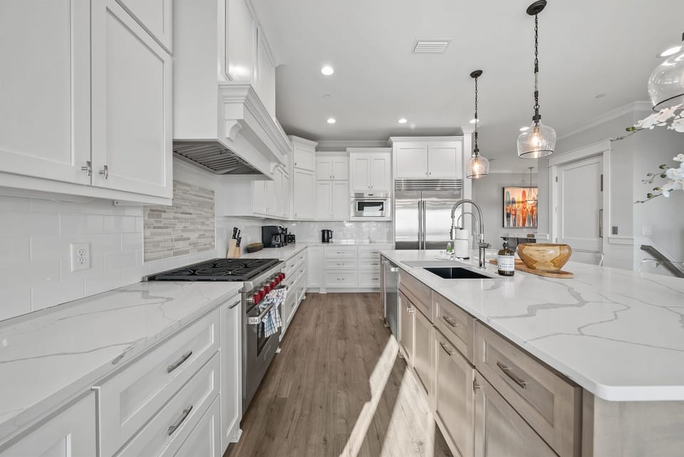 Your gourmet kitchen features pristine marble countertops, professional-grade appliances, and elegant pendant lighting for memorable culinary experiences.