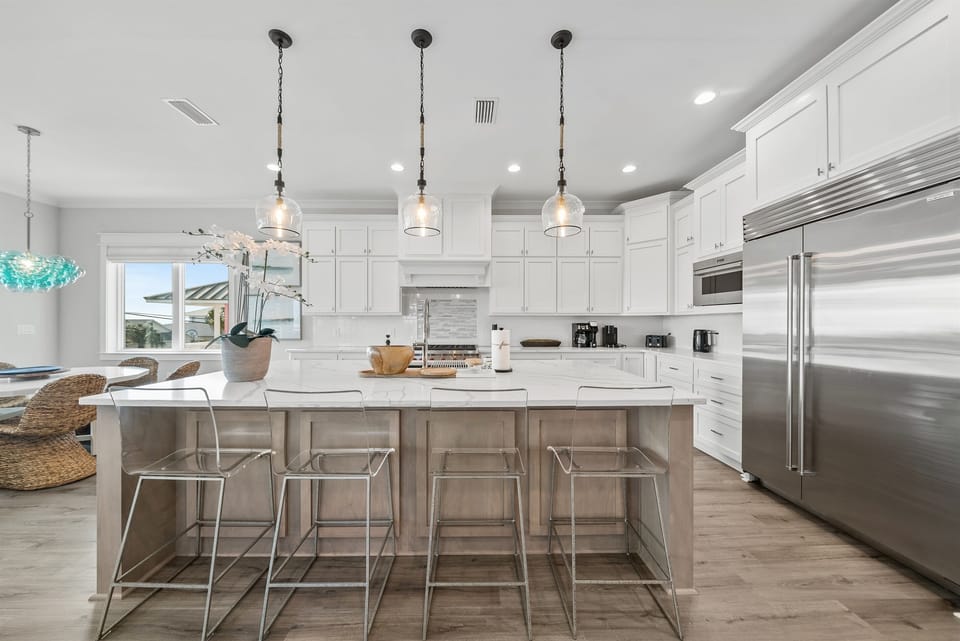 Your gourmet kitchen awaits with marble counters, stainless appliances, and a spacious island perfect for morning coffee or evening meals together.