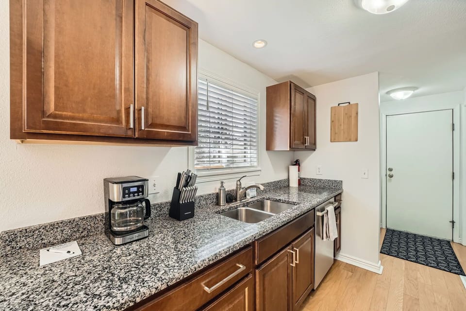 Your fully equipped kitchen awaits with granite counters, modern appliances, and everything needed for home cooking during your stay.