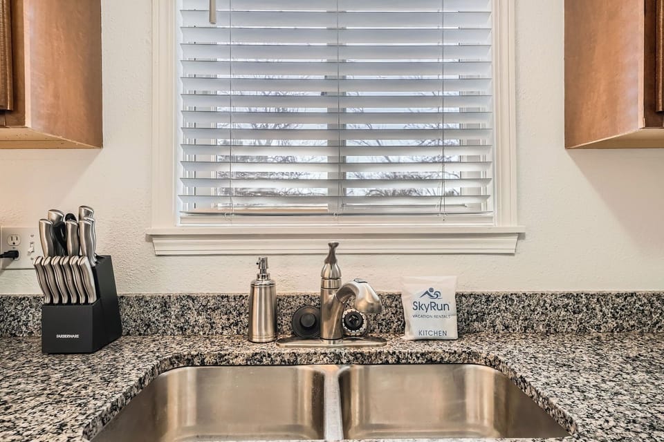 Your well-appointed kitchen sink features granite countertops, quality fixtures, and thoughtful amenities to make meal prep a breeze during your stay.