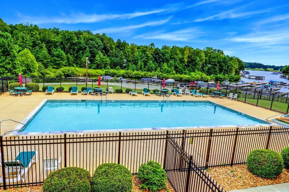 The rental includes access to The Waters community amenities, including a marina, swimming pool, tennis courts, picnic pavilions, a playground, and a sandy beach with lakefront views.