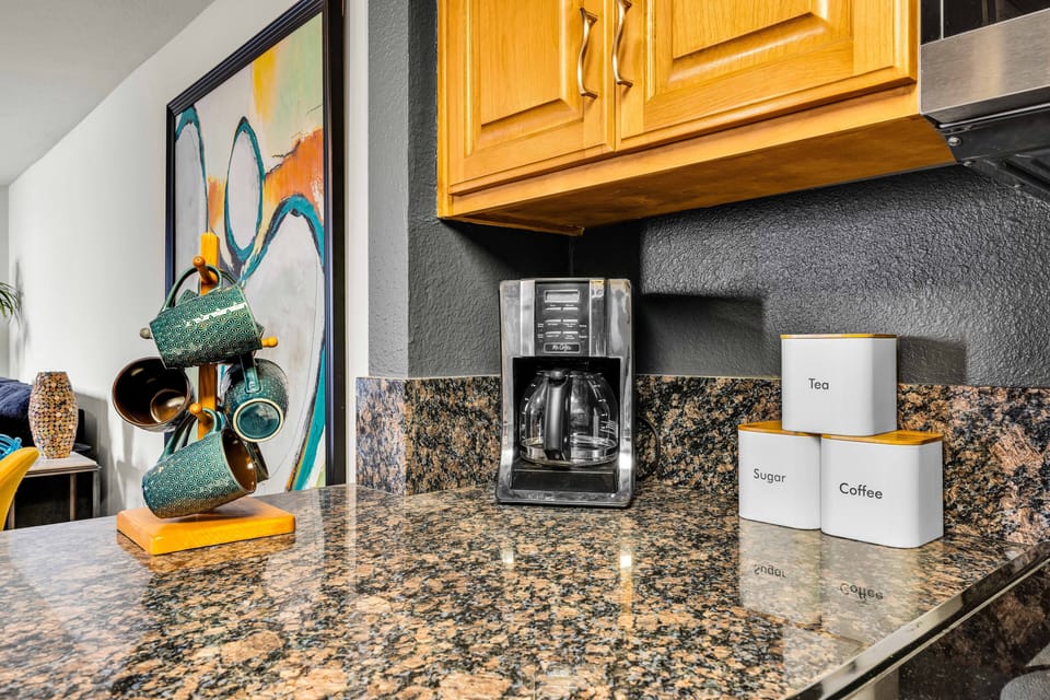 Coffee station with drip coffee maker and complimentary essentials