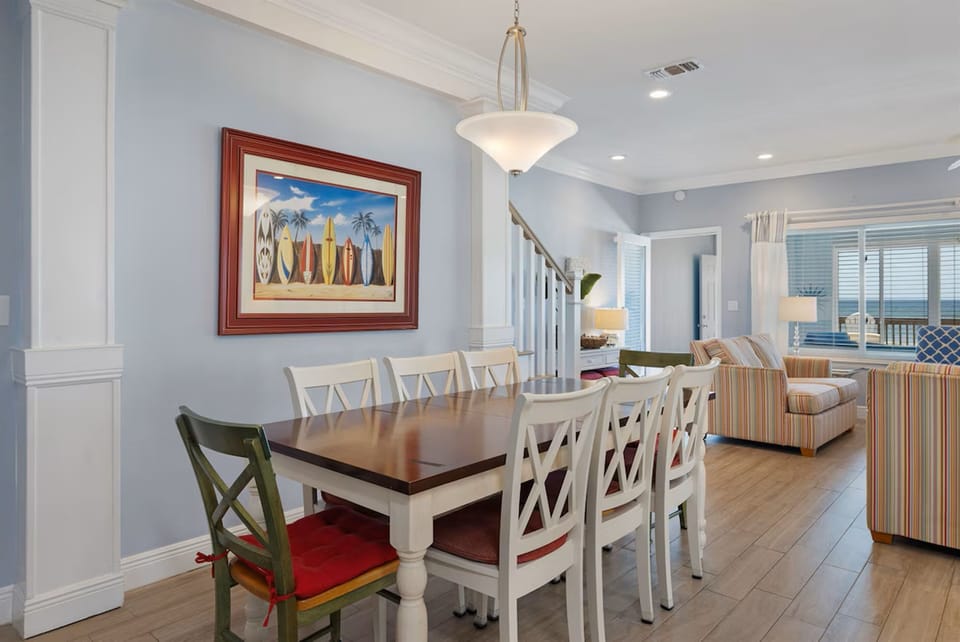 Gather around your spacious dining table for memorable meals, with coastal artwork setting a relaxed beach vibe throughout your open-concept retreat.