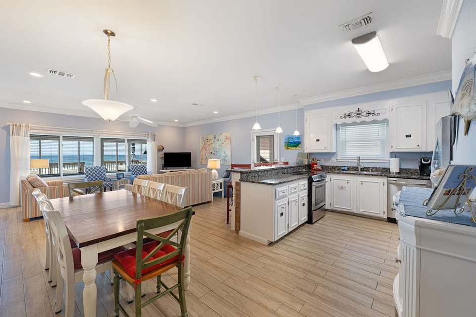 Your spacious open-concept kitchen flows seamlessly into the dining and living areas, where ocean views from your windows create the perfect backdrop for memorable meals.