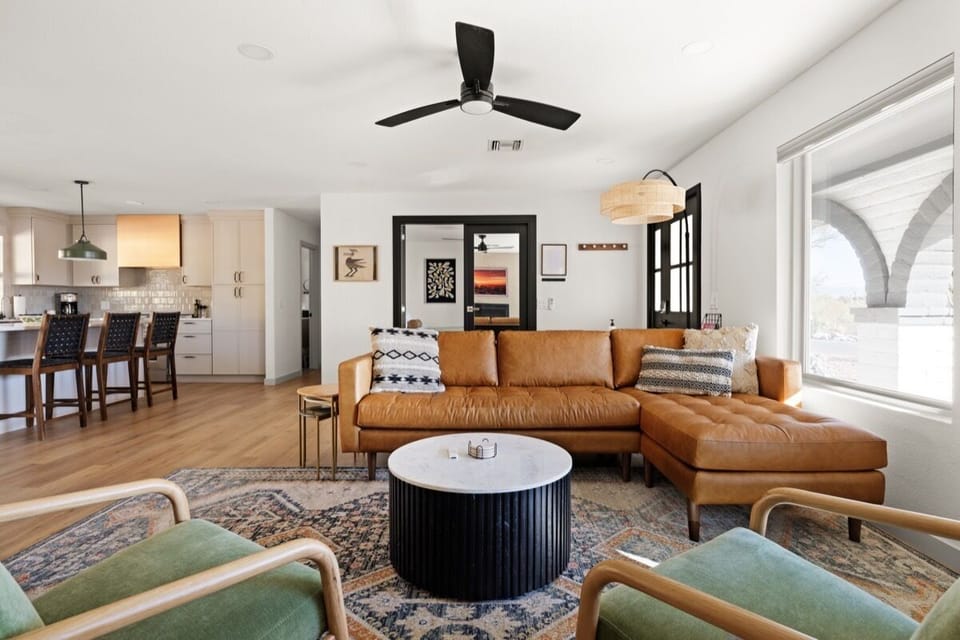 Leather, light wood, & open space create a cozy setting for family and friends.