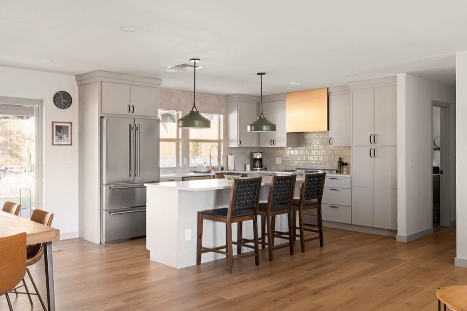 Warm eat-in kitchen with counter seating for cooking, gathering, & sharing meals