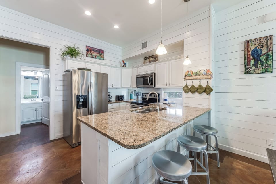 Kitchen - Modern style kitchen with spacious counter tops, stainless steel appliances and inviting breakfast bar that seats 3
