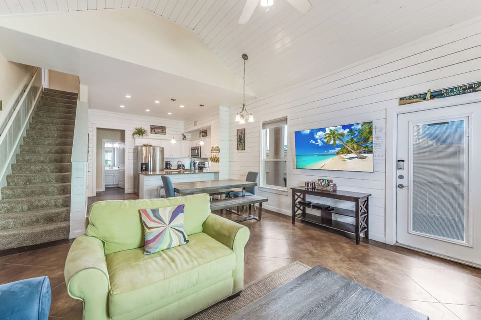Living Area - The living area flows seamlessly into a modern kitchen and dining space, perfect for entertaining family