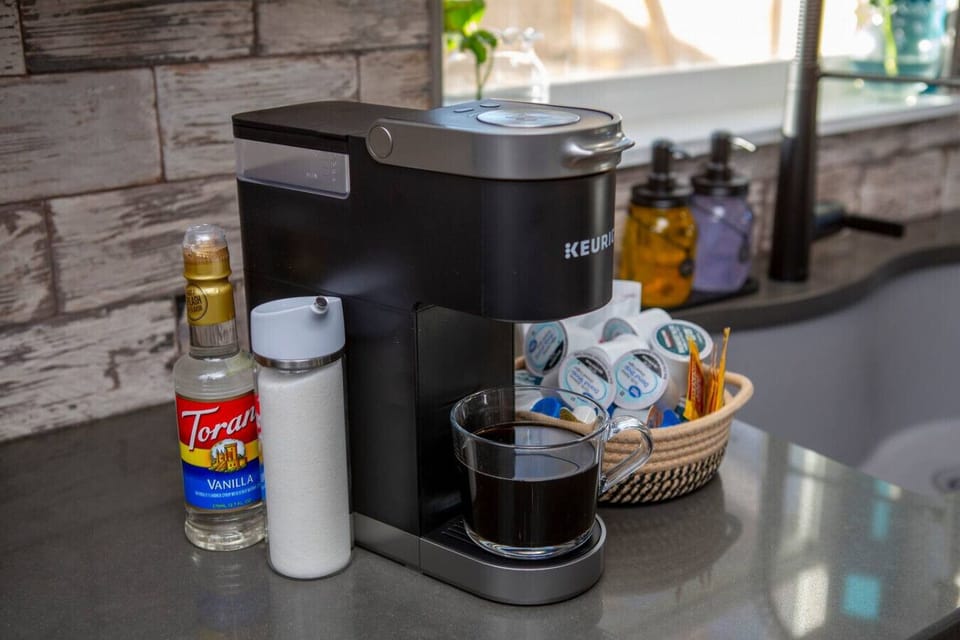Coffee pods, cream, and sugar are supplied.