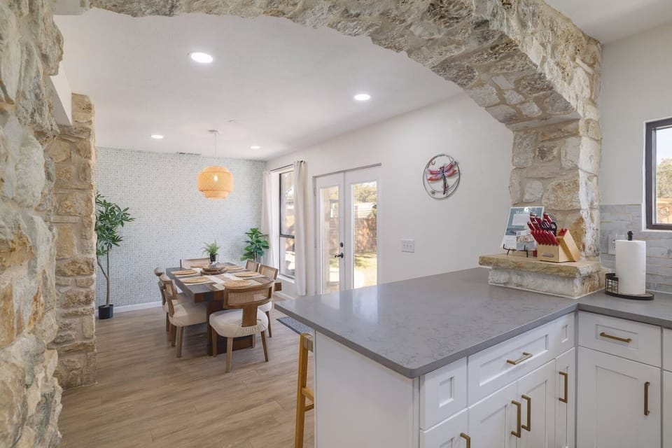 Gather around for slow breakfasts, shared dinners, and easy conversation in a bright dining space framed by beautiful stone archways. Warm textures and natural light make every meal feel a little more special.