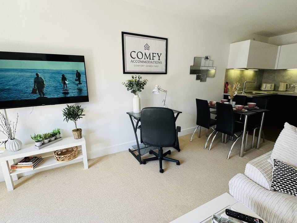 Modern living space with a cozy lounge, dining table, and dedicated workspace. Ideal for business traveler's and long stays