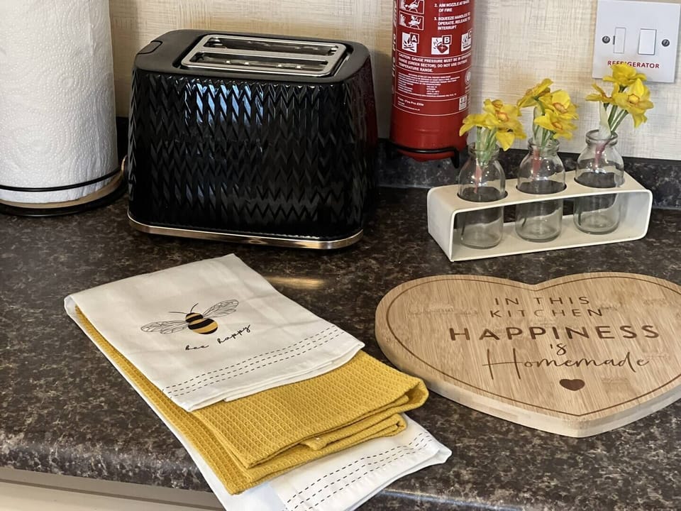 Stylish countertop with a toaster, tea towels & decorative touches—adding charm to your Skegness holiday home.