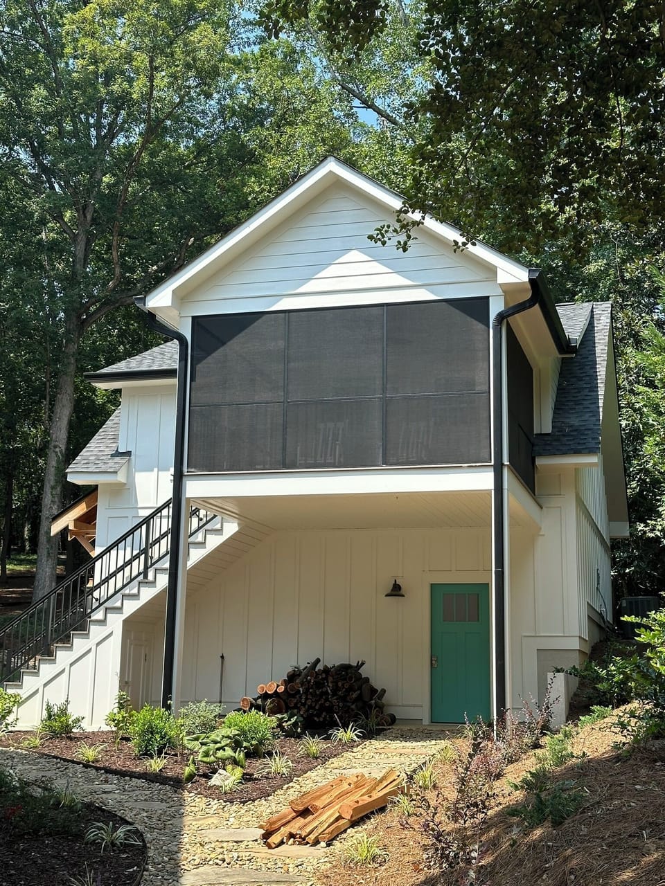 Outside view of screened in porch of bungalow.