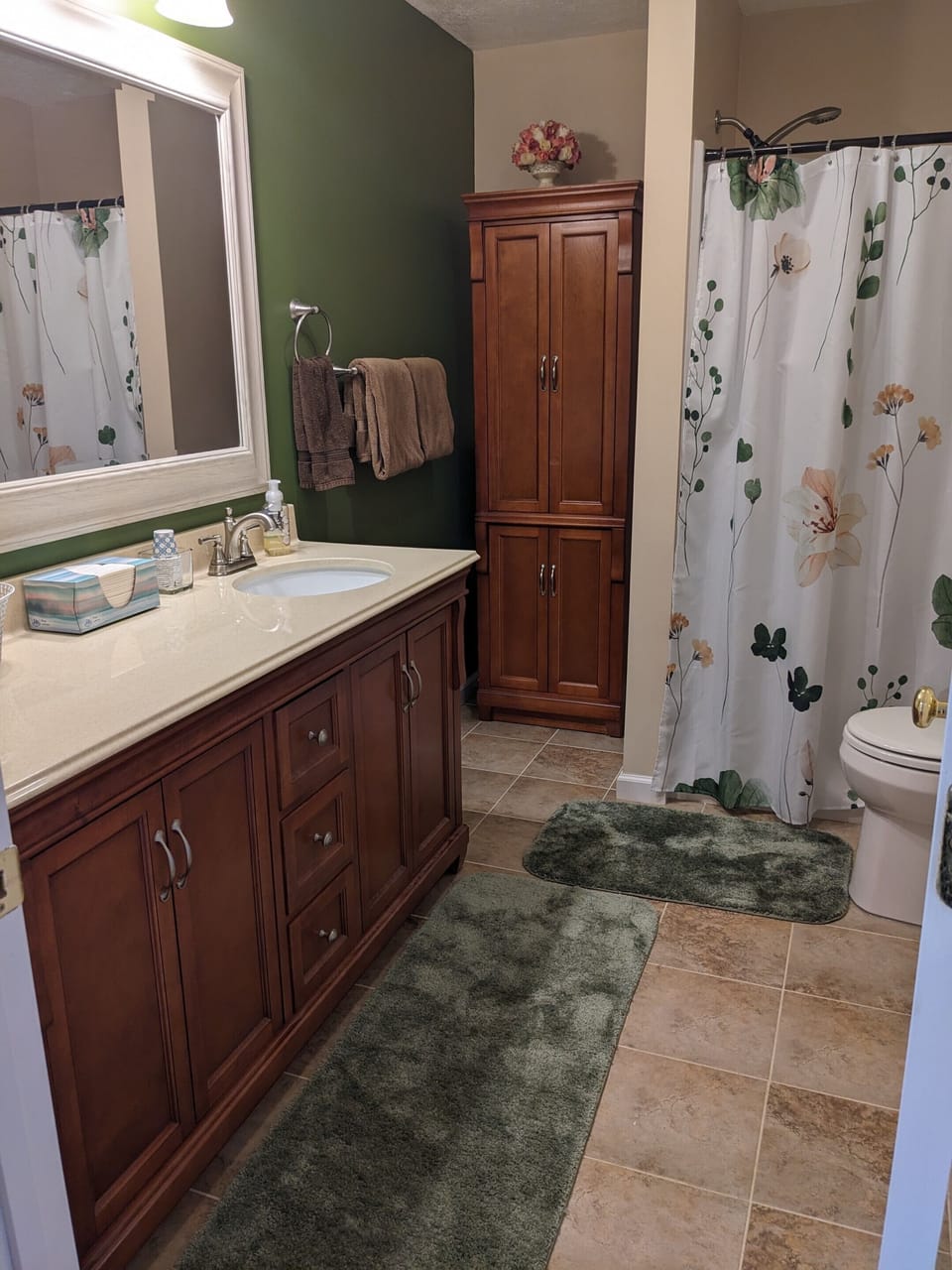 Large bathroom fully stocked with towels and toiletries.